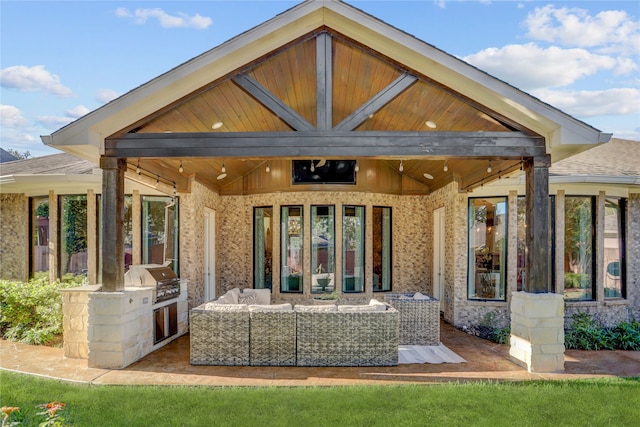 rear view of property featuring area for grilling, a patio area, and an outdoor hangout area