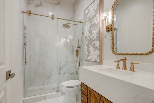 bathroom with vanity, toilet, and an enclosed shower