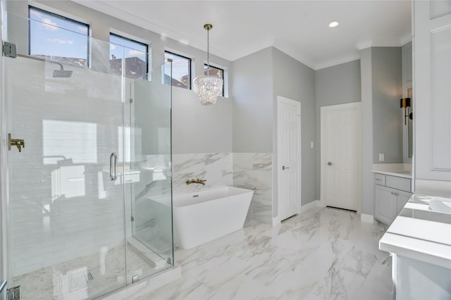 bathroom with separate shower and tub, an inviting chandelier, vanity, and ornamental molding