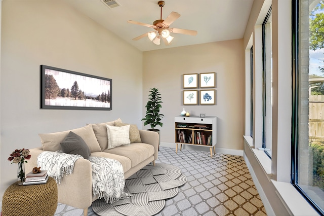 carpeted living room featuring ceiling fan and plenty of natural light