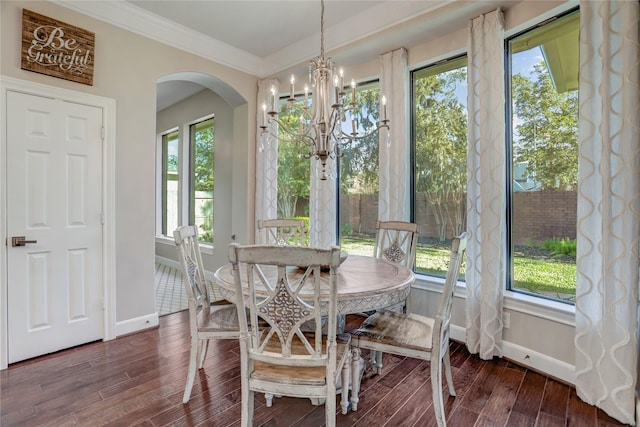 dining area featuring a healthy amount of sunlight, dark hardwood / wood-style flooring, and a chandelier