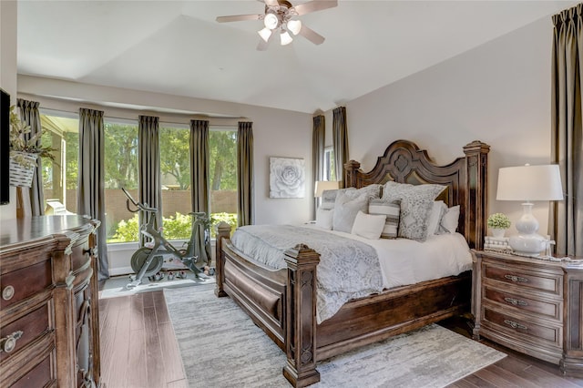 bedroom with ceiling fan, dark hardwood / wood-style flooring, and vaulted ceiling