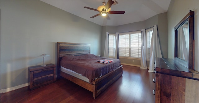 bedroom with vaulted ceiling, ceiling fan, and dark hardwood / wood-style floors