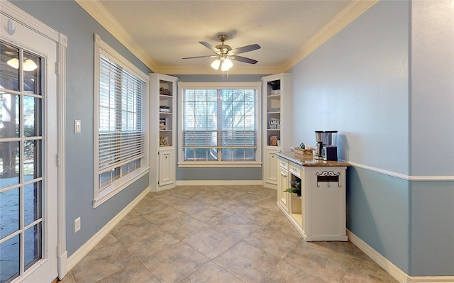 entryway featuring ceiling fan, built in features, and crown molding