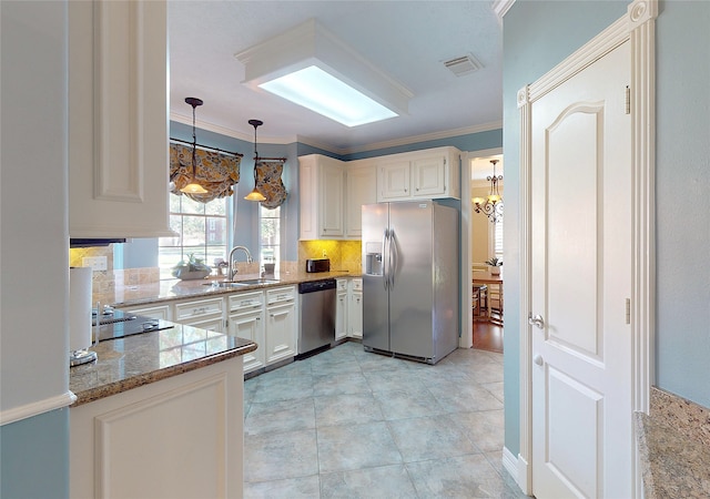 kitchen featuring sink, stainless steel appliances, light stone counters, white cabinets, and ornamental molding