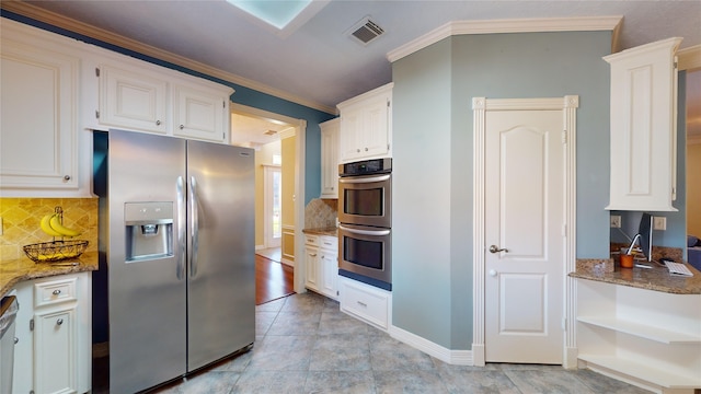 kitchen with decorative backsplash, ornamental molding, stainless steel appliances, stone counters, and white cabinets