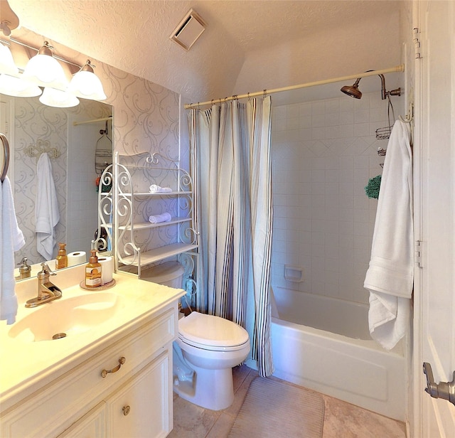 full bathroom with vanity, tile patterned floors, toilet, a textured ceiling, and shower / tub combo with curtain