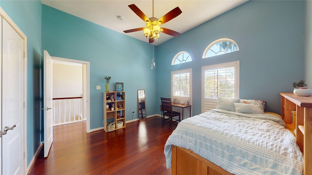 bedroom featuring ceiling fan, dark hardwood / wood-style flooring, and high vaulted ceiling