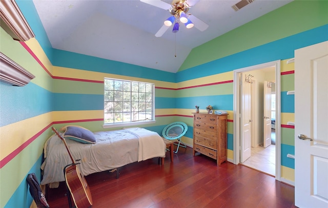 bedroom with vaulted ceiling, ceiling fan, and dark wood-type flooring