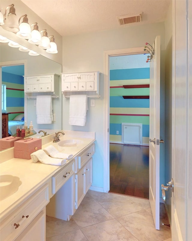 bathroom featuring hardwood / wood-style floors, vanity, and a textured ceiling