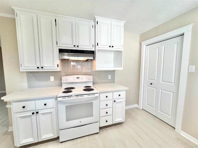 kitchen with electric range, decorative backsplash, white cabinets, and light hardwood / wood-style flooring