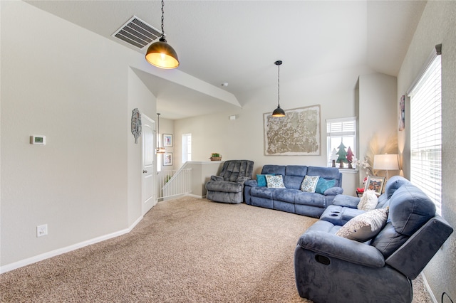 living room featuring carpet, vaulted ceiling, and plenty of natural light