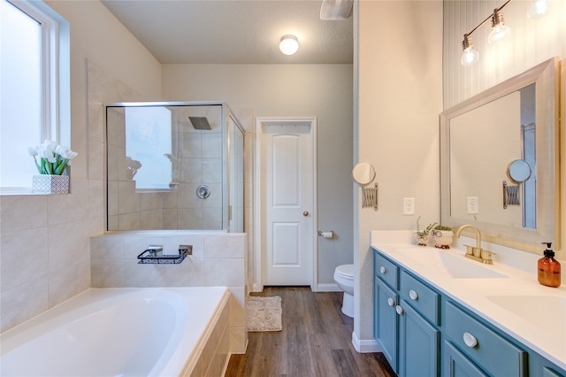 full bathroom with vanity, plus walk in shower, toilet, a textured ceiling, and wood-type flooring