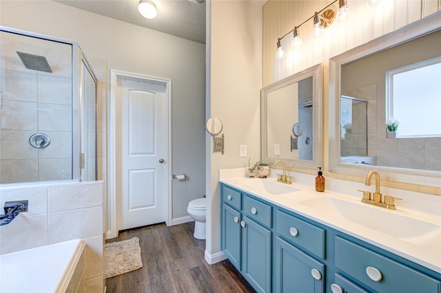 bathroom with vanity, hardwood / wood-style flooring, toilet, a textured ceiling, and an enclosed shower