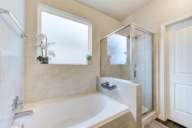 bathroom featuring hardwood / wood-style flooring and separate shower and tub