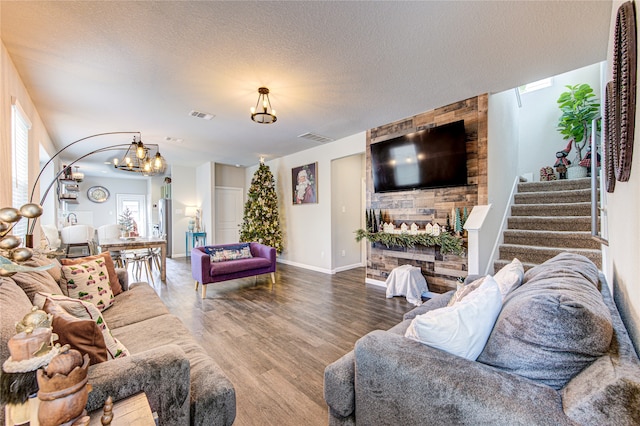 living room with hardwood / wood-style floors and a textured ceiling