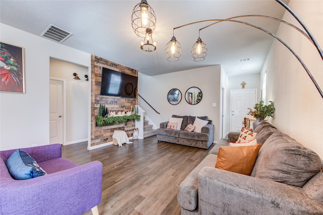 living room featuring a chandelier and wood-type flooring