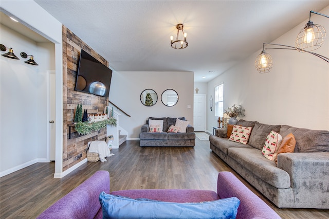 living room with wood-type flooring and a notable chandelier