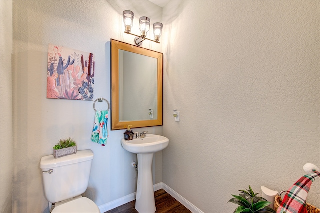 bathroom featuring hardwood / wood-style floors and toilet