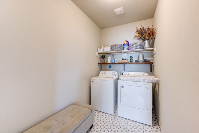 washroom featuring a textured ceiling and washer and clothes dryer