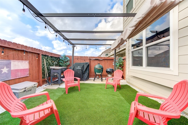 view of patio / terrace with a pergola and area for grilling