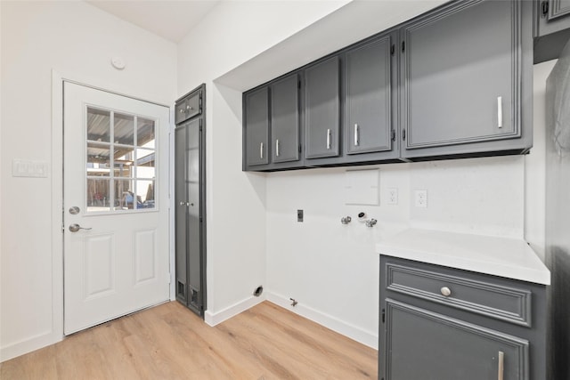 laundry area featuring hookup for an electric dryer, cabinets, hookup for a washing machine, and light hardwood / wood-style flooring