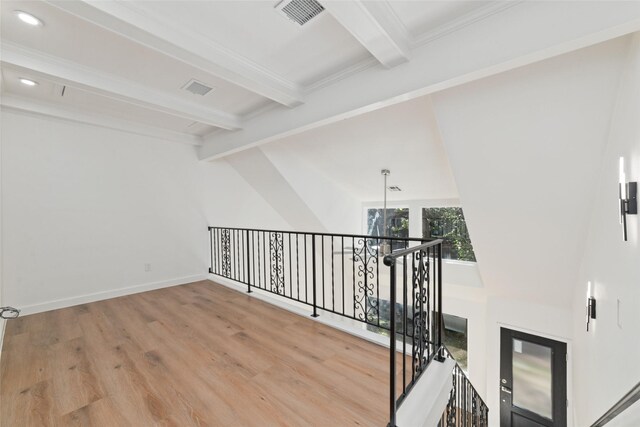 interior space featuring a chandelier, lofted ceiling with beams, and light hardwood / wood-style floors