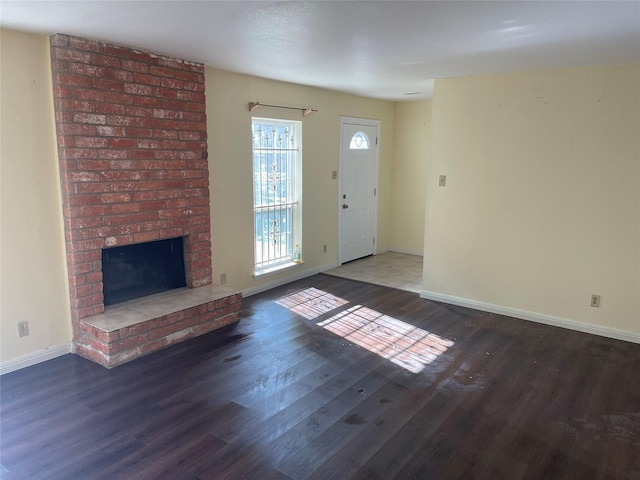 unfurnished living room featuring hardwood / wood-style flooring and a fireplace