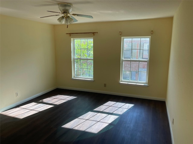 spare room with ceiling fan and dark hardwood / wood-style floors