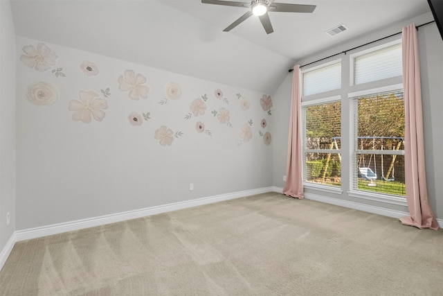 carpeted spare room featuring ceiling fan and lofted ceiling