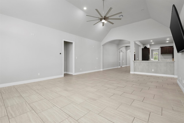 unfurnished living room featuring ceiling fan and lofted ceiling