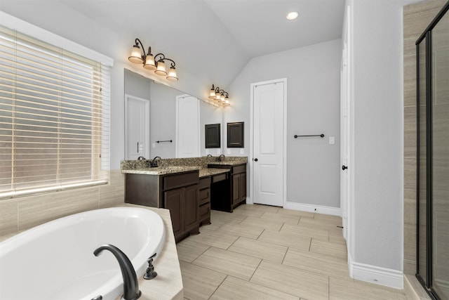 bathroom with shower with separate bathtub, vanity, and lofted ceiling