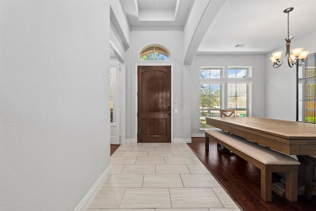 entrance foyer featuring a notable chandelier