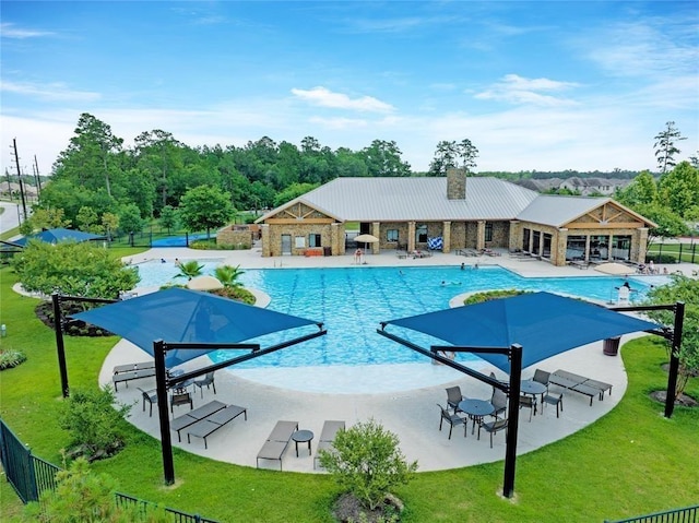 view of pool with a yard and a patio