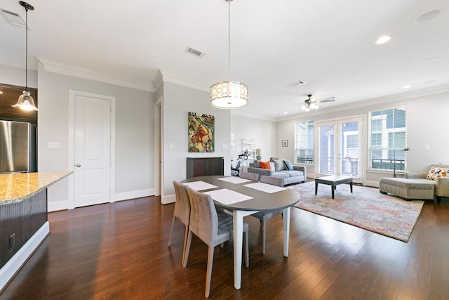 dining room with crown molding, ceiling fan, and dark hardwood / wood-style floors