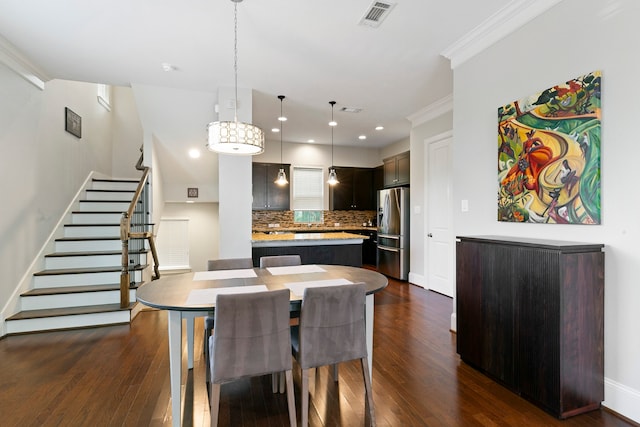 dining room with dark hardwood / wood-style flooring and ornamental molding