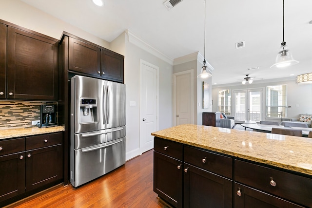 kitchen with stainless steel refrigerator with ice dispenser, dark hardwood / wood-style flooring, dark brown cabinetry, and pendant lighting