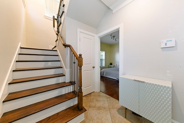 stairway featuring hardwood / wood-style flooring and lofted ceiling