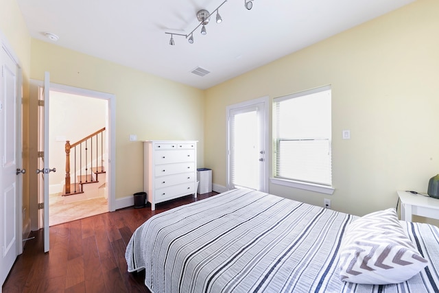 bedroom with dark hardwood / wood-style flooring