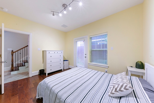 bedroom with dark hardwood / wood-style floors