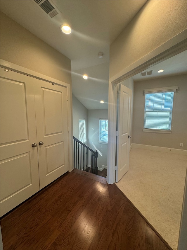 hallway with hardwood / wood-style flooring