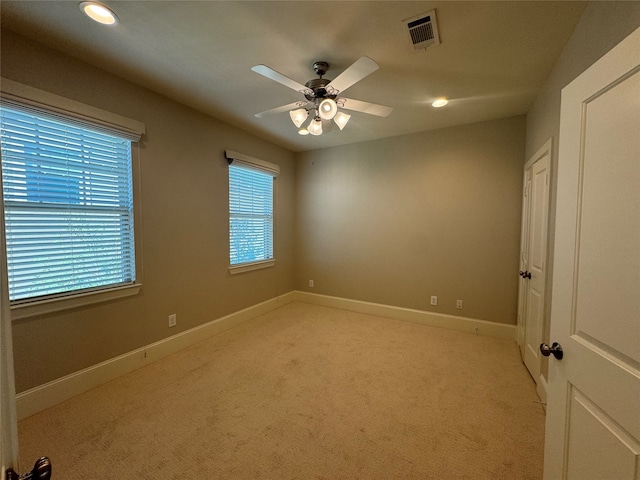 spare room with light carpet and ceiling fan