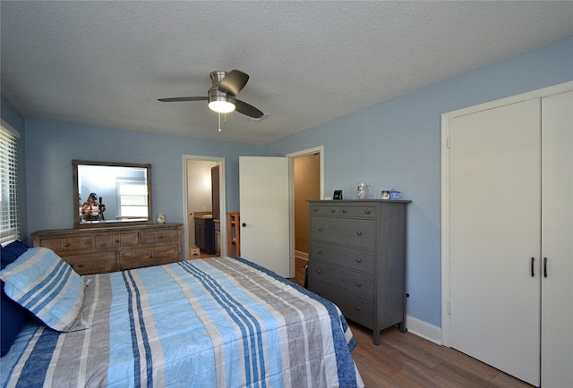 bedroom with hardwood / wood-style floors, ceiling fan, a textured ceiling, and ensuite bath