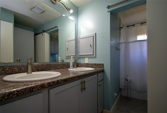 bathroom with vanity, a textured ceiling, tile patterned floors, and a shower with shower curtain