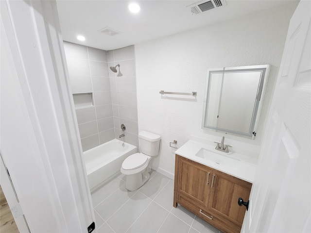 full bathroom with tiled shower / bath, tile patterned flooring, vanity, and toilet