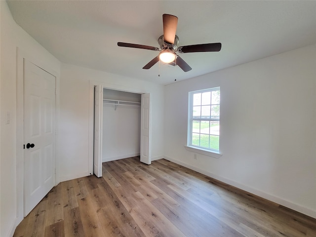 unfurnished bedroom with a closet, ceiling fan, and light hardwood / wood-style flooring