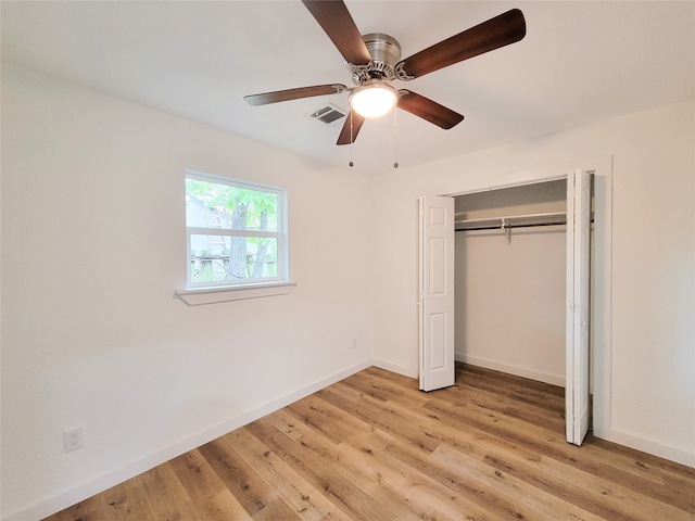 unfurnished bedroom featuring light wood-type flooring, a closet, and ceiling fan