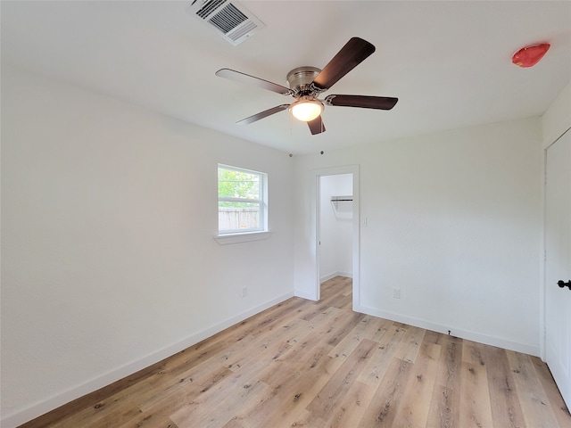 spare room featuring ceiling fan and light hardwood / wood-style floors