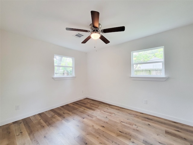 unfurnished room with plenty of natural light, ceiling fan, and light hardwood / wood-style flooring