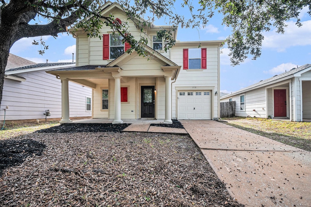 view of front of property featuring a porch and a garage